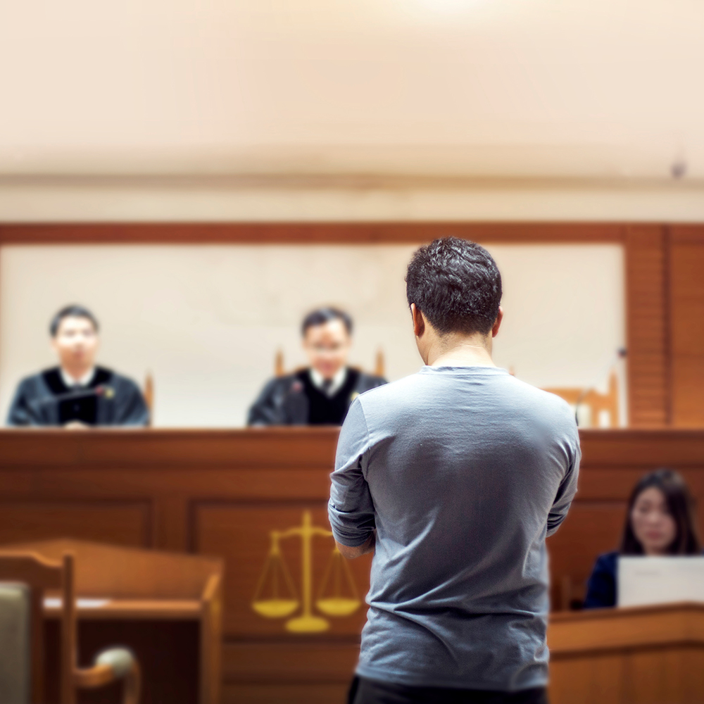 Man Standing Trial in the Court Room - East Coast Legal Group