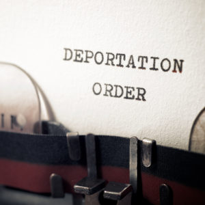 Sponsoring Someone For Immigration Benefits - Deportation Order on Typewriter - East Coast Legal Group